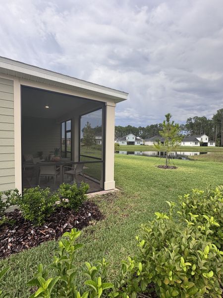 A charming home with a screened porch and lush greenery in Trailmark by Lennar, St. Augustine, FL.