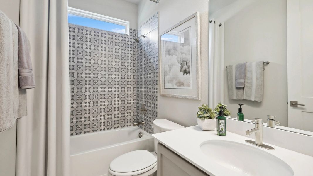 Refined geometric tile enhances this Hulen Trails bathroom's modern elegance and sophisticated design. Refined geometric tile enhances this Hulen Trails bathroom's modern elegance and sophisticated design.