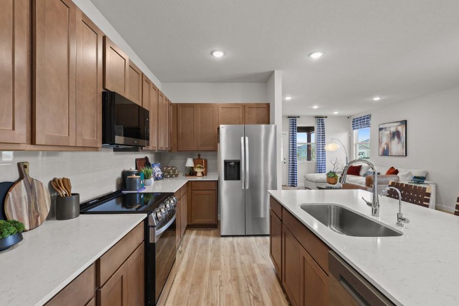 A kitchen with wooden cabinets.