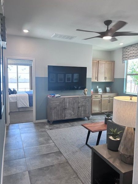 A modern living area featuring sleek cabinetry, a cozy sitting space, and a large TV for entertainment. A modern living area featuring sleek cabinetry, a cozy sitting space, and a large TV for entertainment.