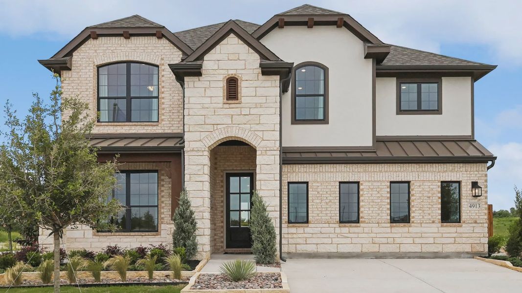 Elegant stone facade with arched entryway and expansive windows exemplifies luxury in Hulen Trails. Elegant stone facade with arched entryway and expansive windows exemplifies luxury in Hulen Trails.