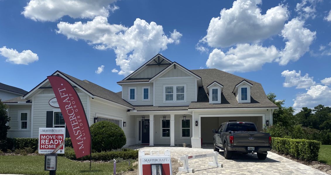 A beautiful modern home with a gabled roof and a tidy driveway in SilverLeaf by MasterCraft Builder Group (St. Augustine, FL).