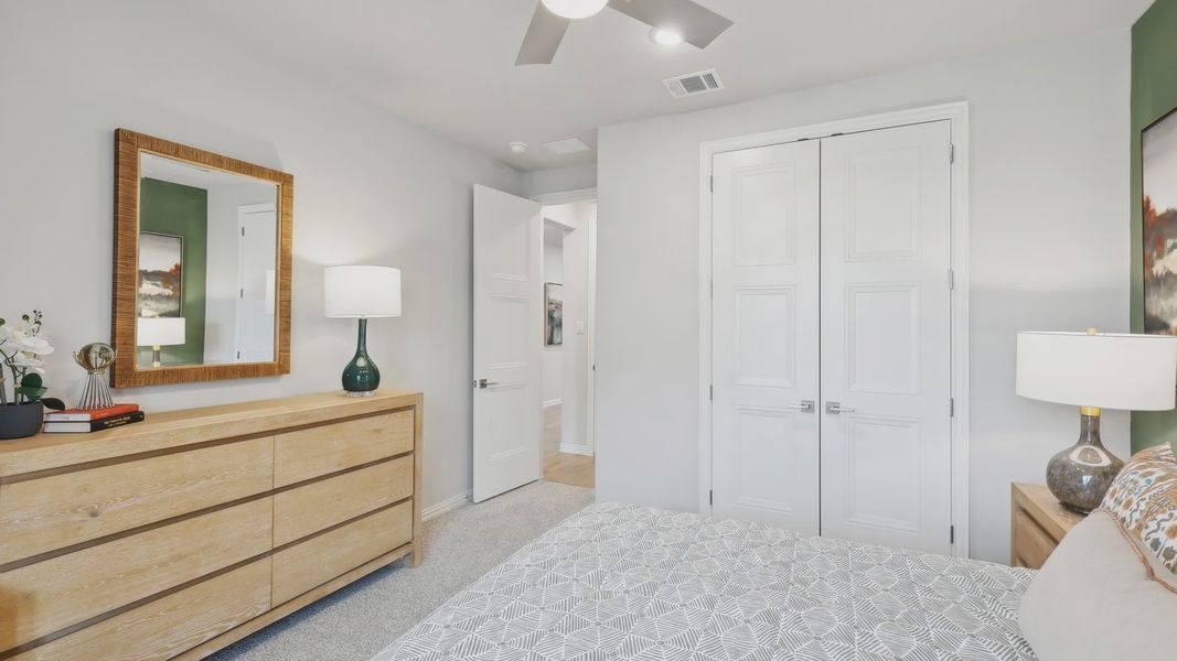 Luxurious bedroom in Wildflower Ranch boasts a sleek wood dresser and stylish ceiling fan, exuding modern elegance. Luxurious bedroom in Wildflower Ranch boasts a sleek wood dresser and stylish ceiling fan, exuding modern elegance.