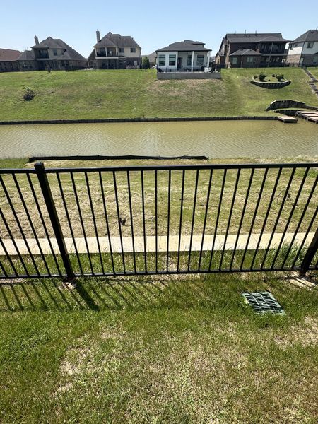 Scenic waterfront view with modern homes in Waterstone on Lake Conroe by K. Hovnanian® Homes (Montgomery, TX).