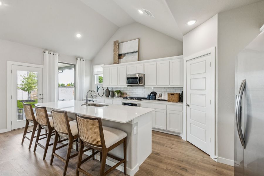 REPRESENTATIVE PHOTO – Kitchen in a Lakehaven Wimbledon model home in Farmersville TX by Trophy Signature Homes