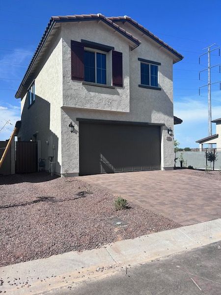 A modern two-story home with a stone driveway in Mandarin at Citrus Park by Landsea Homes (Goodyear, AZ).