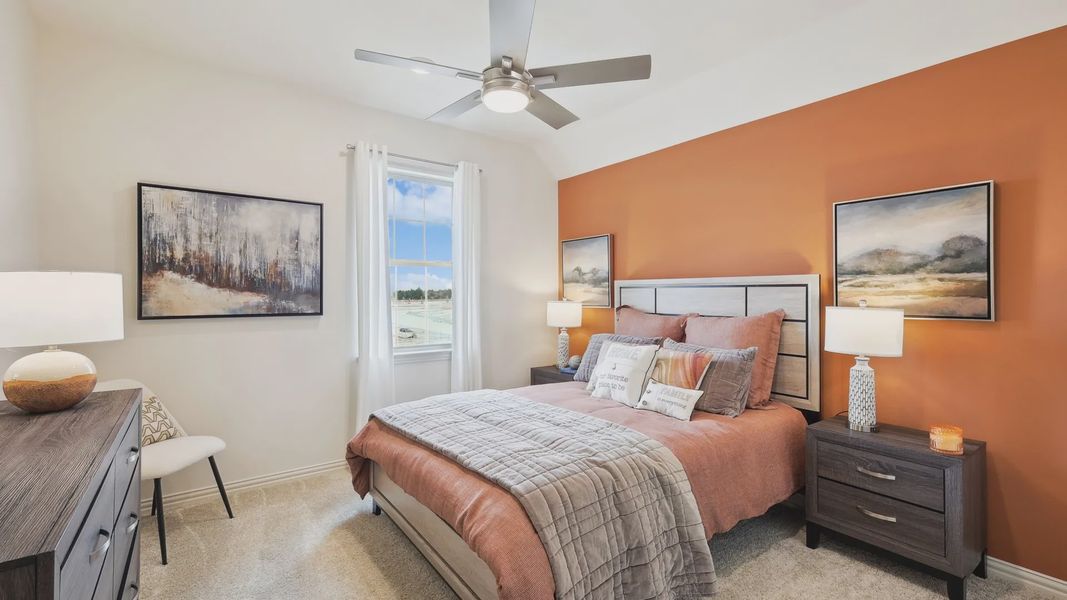 The Oaks' bedroom features elegant orange accents and sophisticated decor for premium comfort.