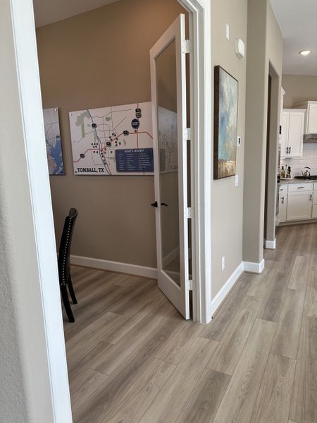A modern room with light wood flooring, a map of Tomball, TX, and neutral decor creating a welcoming workspace. A modern room with light wood flooring, a map of Tomball, TX, and neutral decor creating a welcoming workspace.