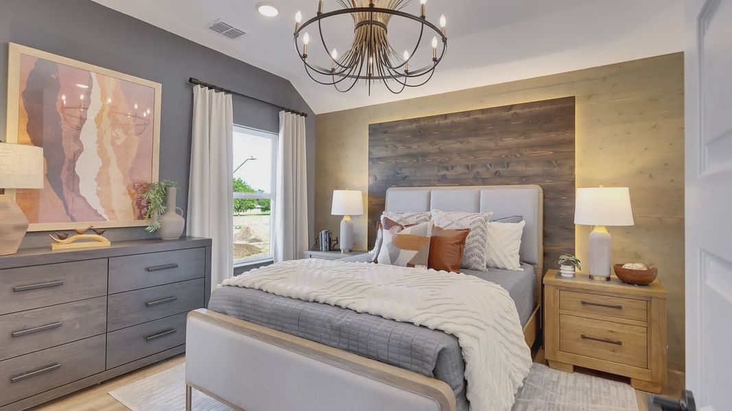 Exquisite wood accent wall and chandelier enhance this sophisticated Spring Creek bedroom.