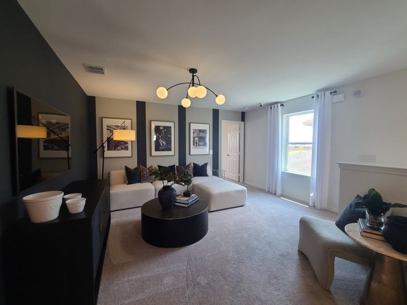 A chic living room featuring a modern chandelier, sleek decor, and cozy seating. A chic living room featuring a modern chandelier, sleek decor, and cozy seating.