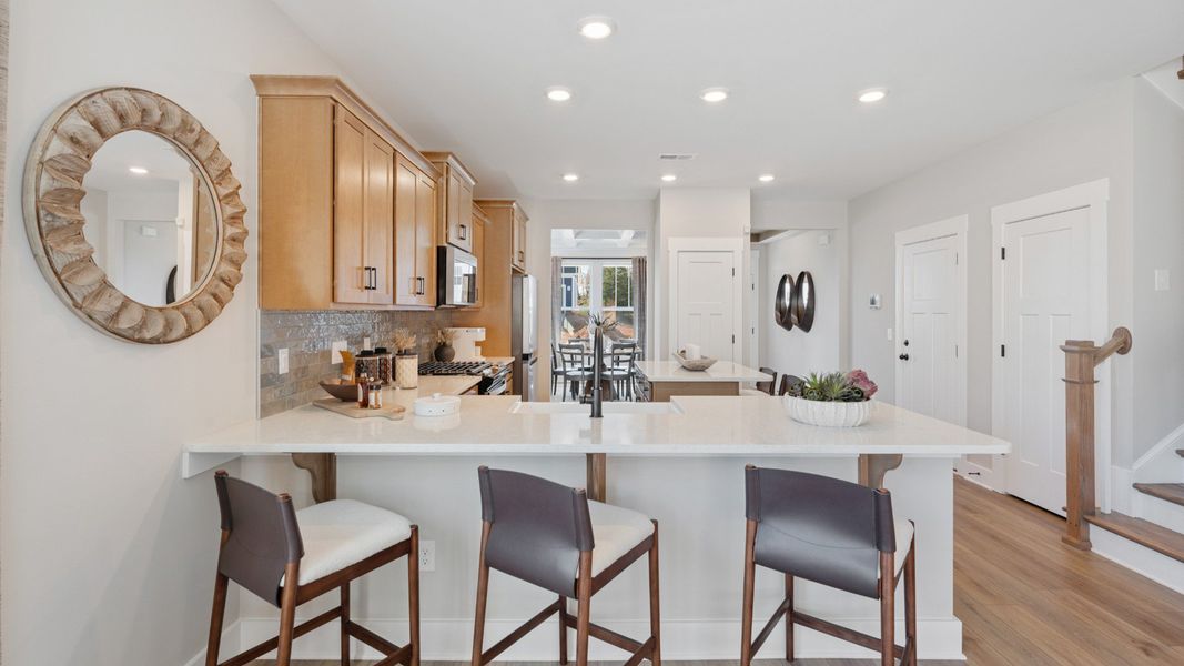 Superior craftsmanship shines in this modern kitchen with a space-saving island and open flow Superior craftsmanship shines in this modern kitchen with a space-saving island and open flow