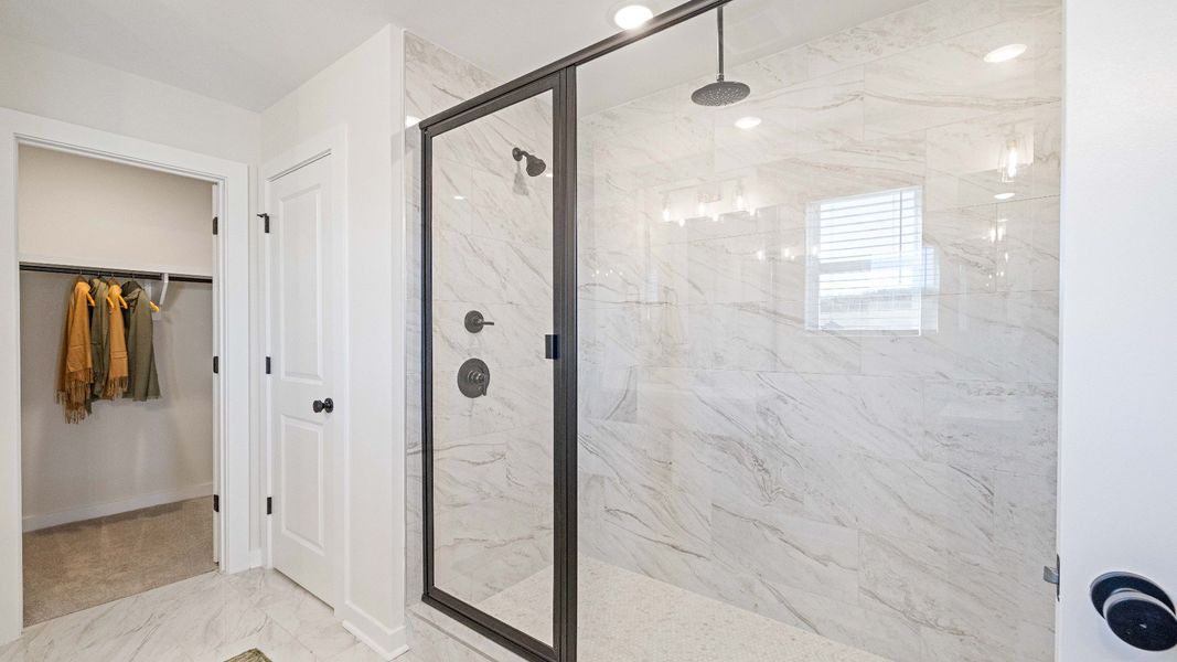 Tile shower with glass enclosure and walk-in closet Tile shower with glass enclosure and walk-in closet