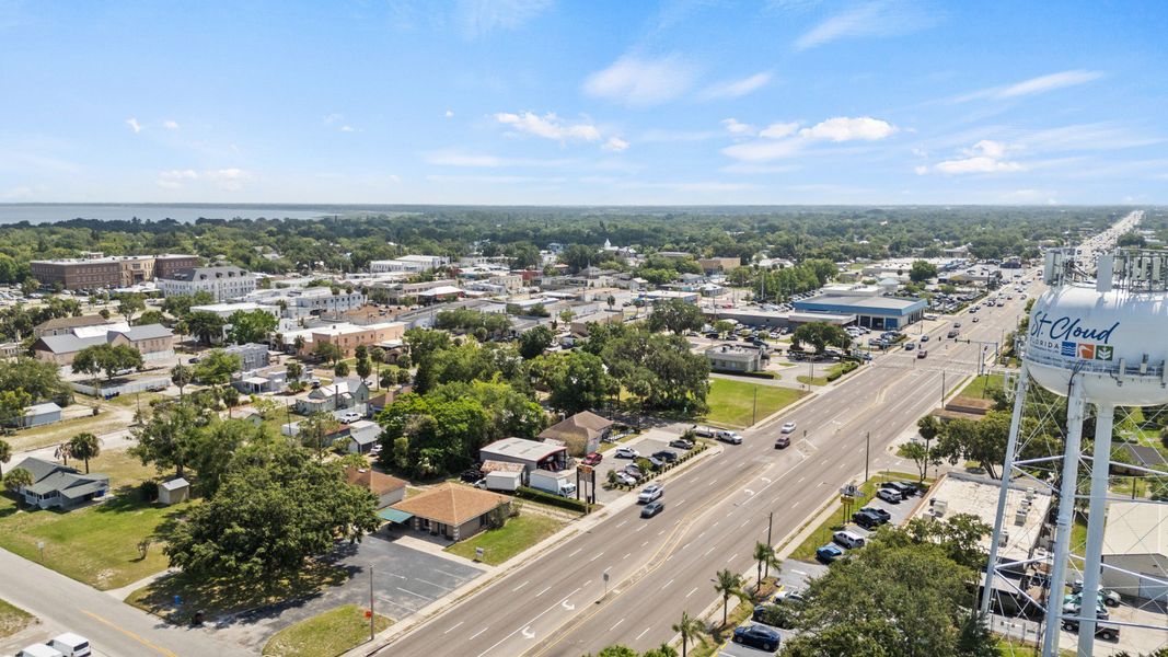 Aerial view of downtown St. Cloud, FL featuring the water tower, local streets, and businesses near Cyrene at Harmony. Aerial view of downtown St. Cloud, FL featuring the water tower, local streets, and businesses near Cyrene at Harmony.