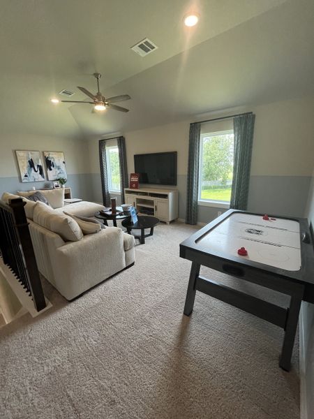 A cozy game room with plush seating, air hockey table, and natural light, creating a perfect entertainment space. A cozy game room with plush seating, air hockey table, and natural light, creating a perfect entertainment space.