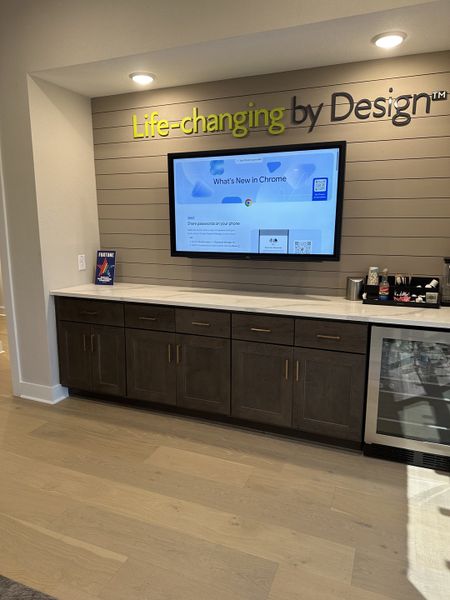 A modern media nook with a sleek TV, dark wood cabinetry, and stylish lighting. Perfect for entertainment and relaxation.