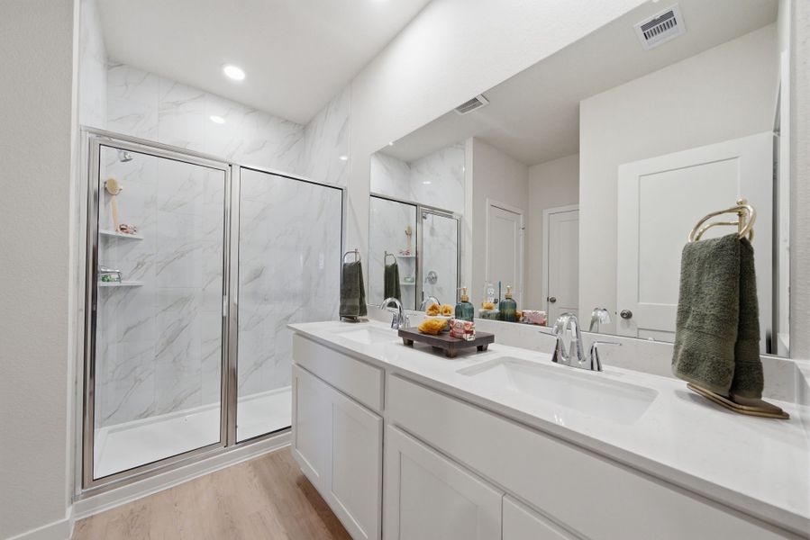 A bathroom with a glass shower. A bathroom with a glass shower.