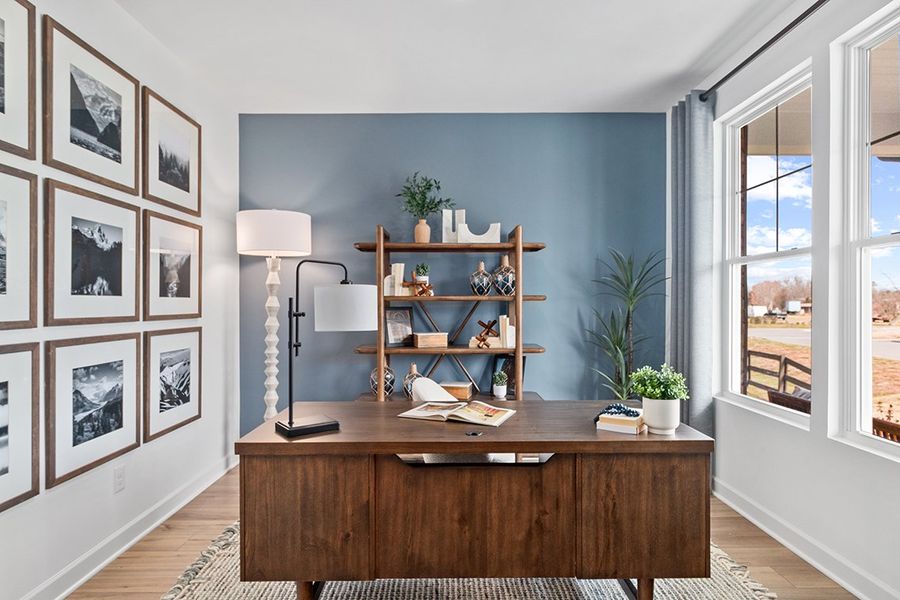 A desk with a lamp and books on it. A desk with a lamp and books on it.