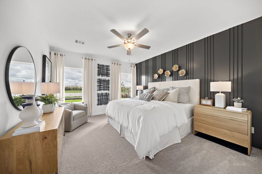 A bedroom with a large bed and a large fan.