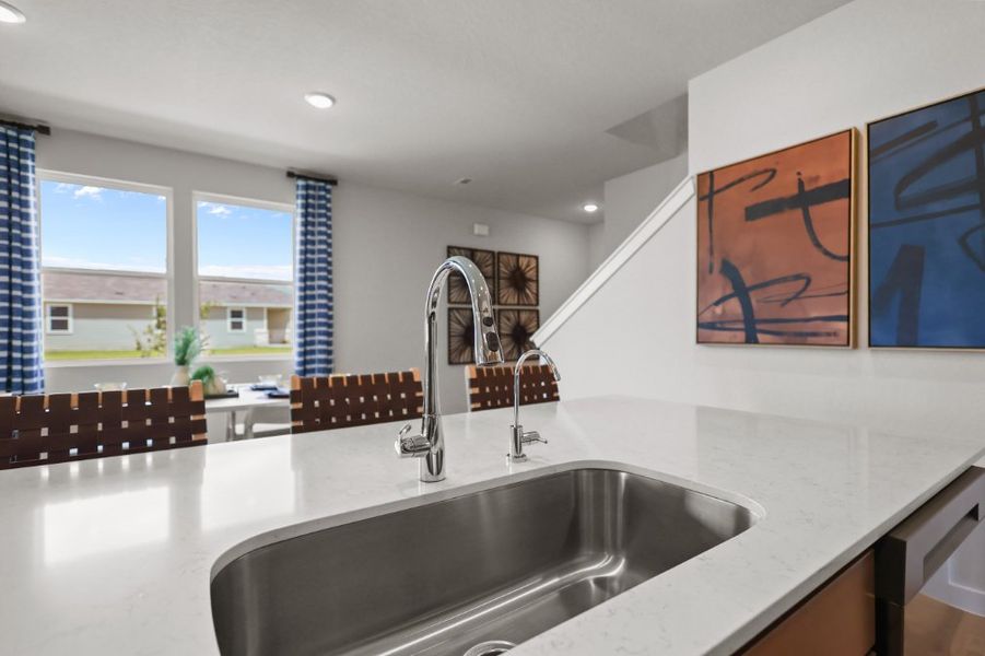 A kitchen with a sink and a window.