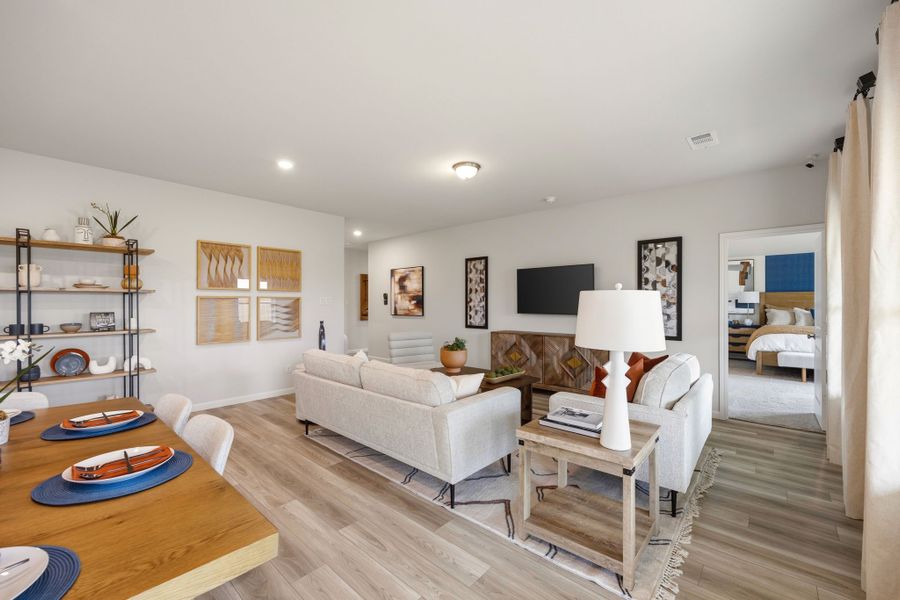 A living room with a large white couch and a table. A living room with a large white couch and a table.