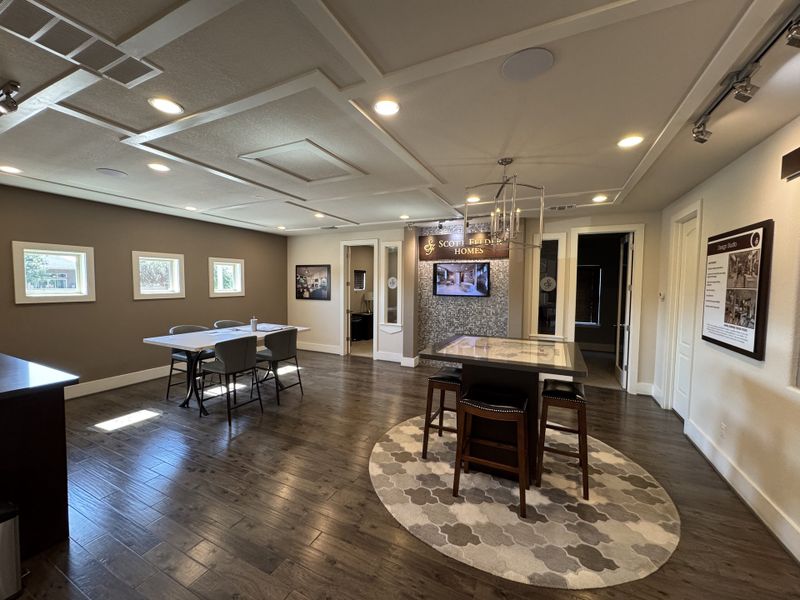 A modern meeting room with wooden floors, elegant lighting, and chic furnishings.