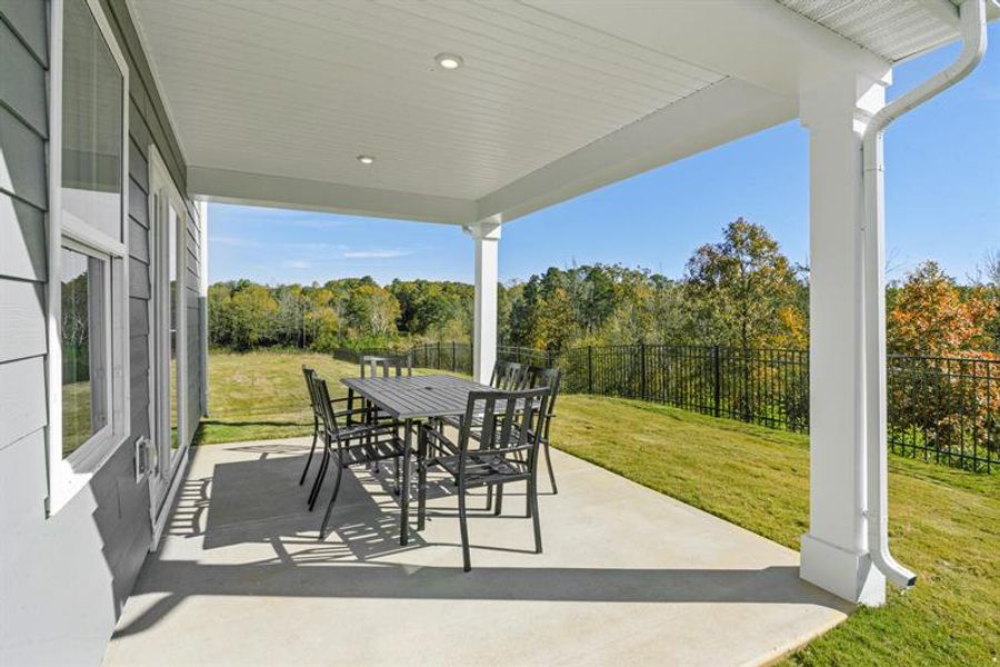 Bring your living space outside with a beautiful covered patio overlooking your spacious yard.