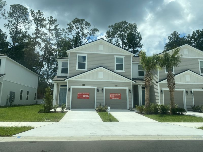 A modern duplex with gray siding and lush landscaping in Briarwood by D.R. Horton, Jacksonville, FL. A modern duplex with gray siding and lush landscaping in Briarwood by D.R. Horton, Jacksonville, FL.