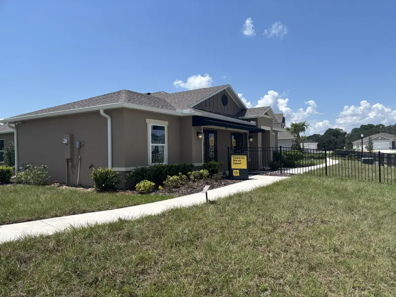 A charming single-story home with a tidy lawn and inviting path in Silver Lake Estates I by KB Home (Leesburg, FL).