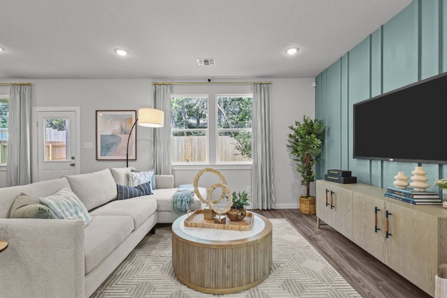 A living room with a tv and a couch. A living room with a tv and a couch.