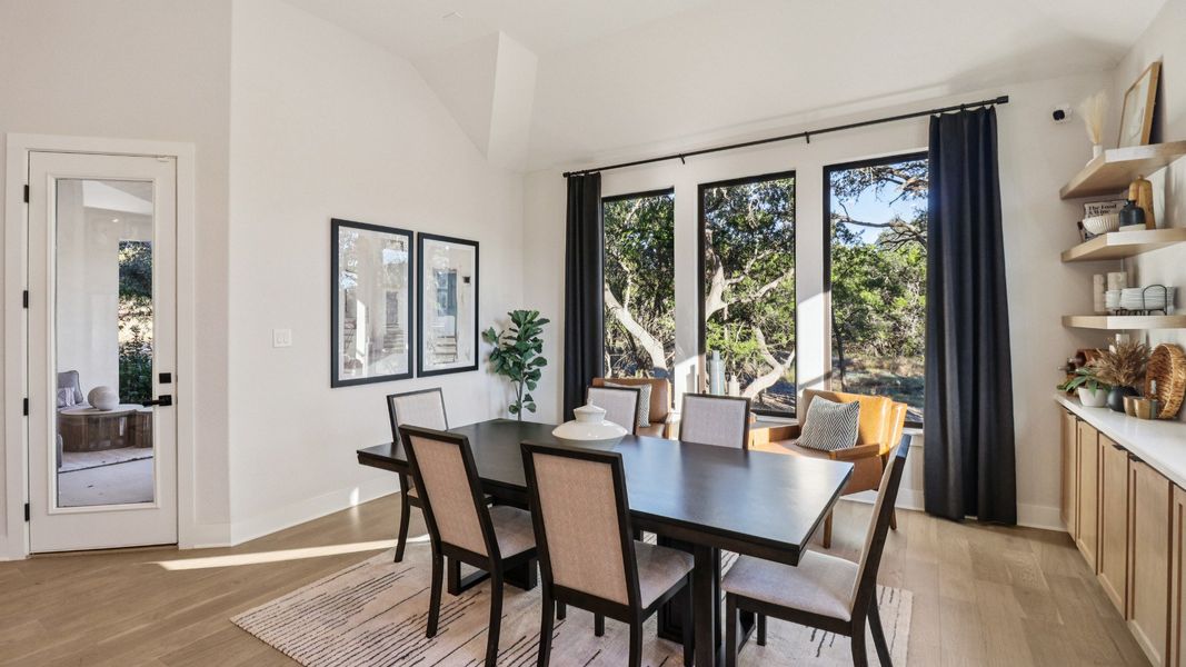 Elegant kitchen with custom wood cabinets, expansive island, and chic pendant lights in Verandas at the Rim. Elegant kitchen with custom wood cabinets, expansive island, and chic pendant lights in Verandas at the Rim.