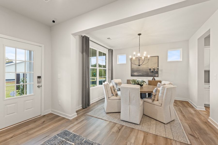 A living room with a white couch and a white rug.