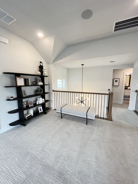 A modern loft space with plush carpeting, sleek shelving, and elegant lighting creating a cozy retreat. A modern loft space with plush carpeting, sleek shelving, and elegant lighting creating a cozy retreat.