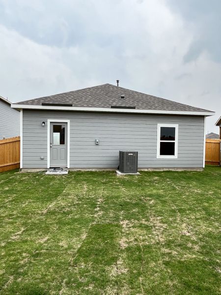 A modern gray home with a neat backyard in Big Sky Estates by LGI Homes (Ponder, TX).