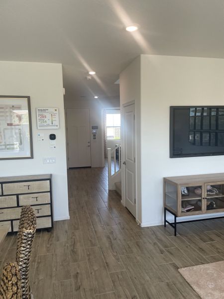 A modern interior with wood-look flooring, sleek furniture, and bright recessed lighting creating a welcoming ambiance.