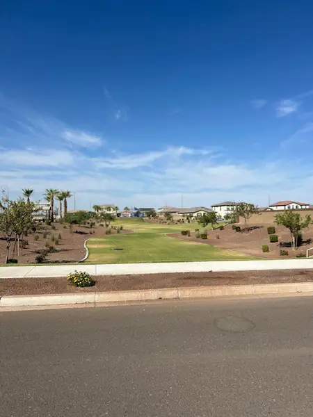 A scenic neighborhood park with manicured lawns in Ventana de Estrellas Enclaves by KB Home, Goodyear, AZ.
