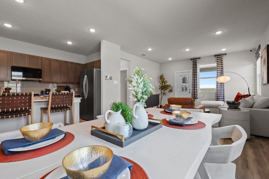 A large kitchen with a dining table.