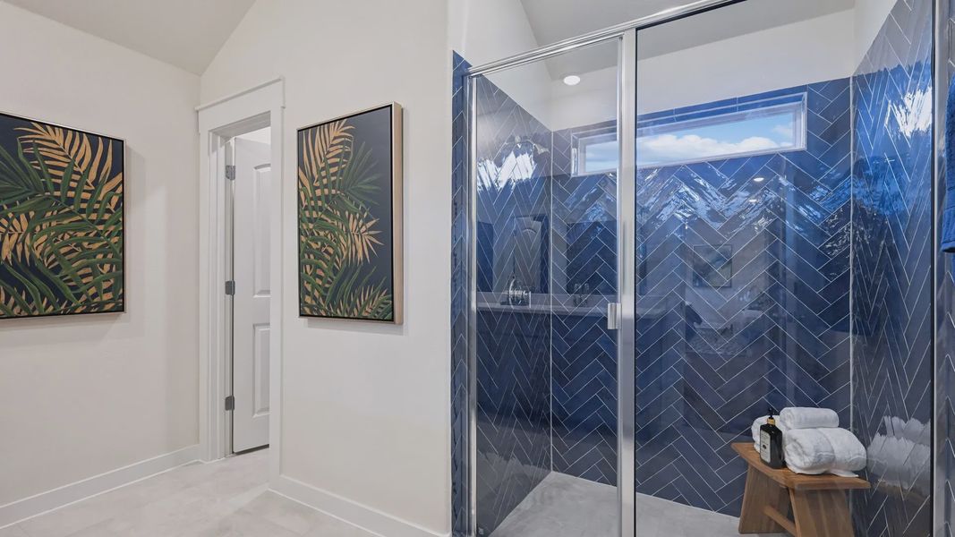 Indulge in this luxurious Churchill bathroom featuring bespoke blue herringbone tiles and striking tropical wall art. Indulge in this luxurious Churchill bathroom featuring bespoke blue herringbone tiles and striking tropical wall art.
