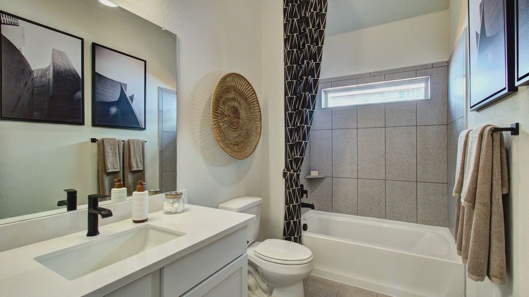 Luxurious bathroom blends modern fixtures, geometric tiles, and elegant wall art in Meyer Ranch, Texas. Luxurious bathroom blends modern fixtures, geometric tiles, and elegant wall art in Meyer Ranch, Texas.