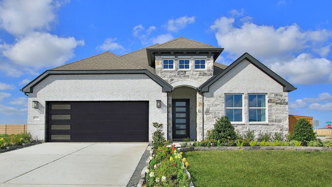 Elegant facade featuring premium brick and stone detailing in River Ranch. Beautifully landscaped entry.