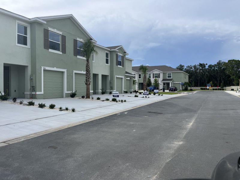 Modern duplex homes with clean lines and manicured lawns in Ruskin Reserve by D.R. Horton (Ruskin, FL).