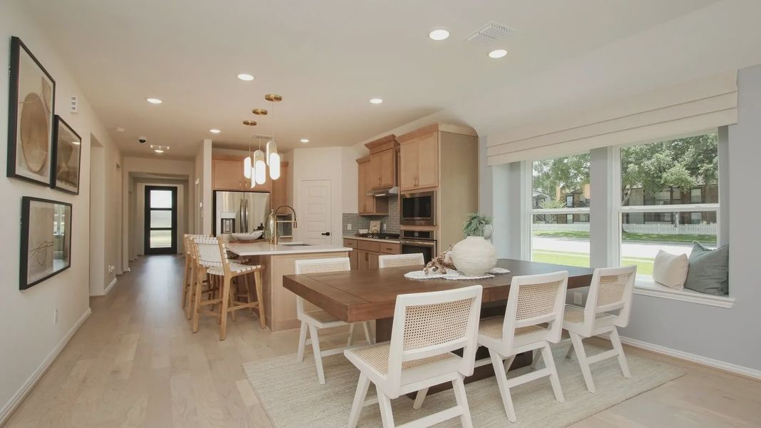 Experience refined elegance with light wood floors and sleek lighting in Ellis Cove's modern kitchen-dining space. Experience refined elegance with light wood floors and sleek lighting in Ellis Cove's modern kitchen-dining space.