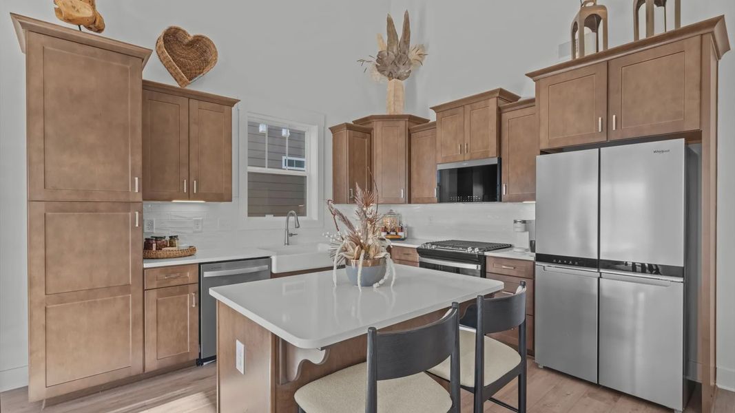 Gorgeous two story ceiling kitchen with wood cabinetry and white quartz countertops by DRB Homes in Greenville, SC