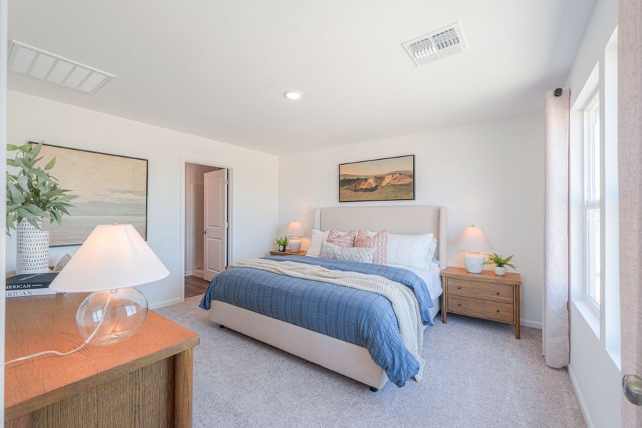 A bedroom with a bed and lamps. A bedroom with a bed and lamps.