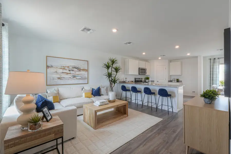 A living room with a couch and chairs. A living room with a couch and chairs.