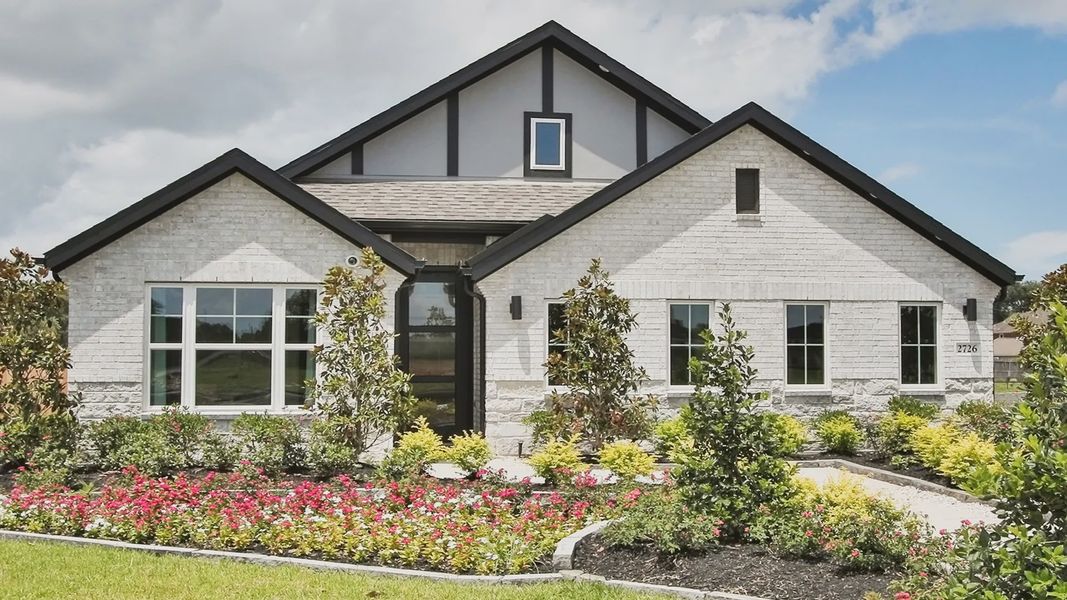 Elegant white brick facade with striking black accents in Ellis Cove. Lush landscaping enhances modern charm. Elegant white brick facade with striking black accents in Ellis Cove. Lush landscaping enhances modern charm.