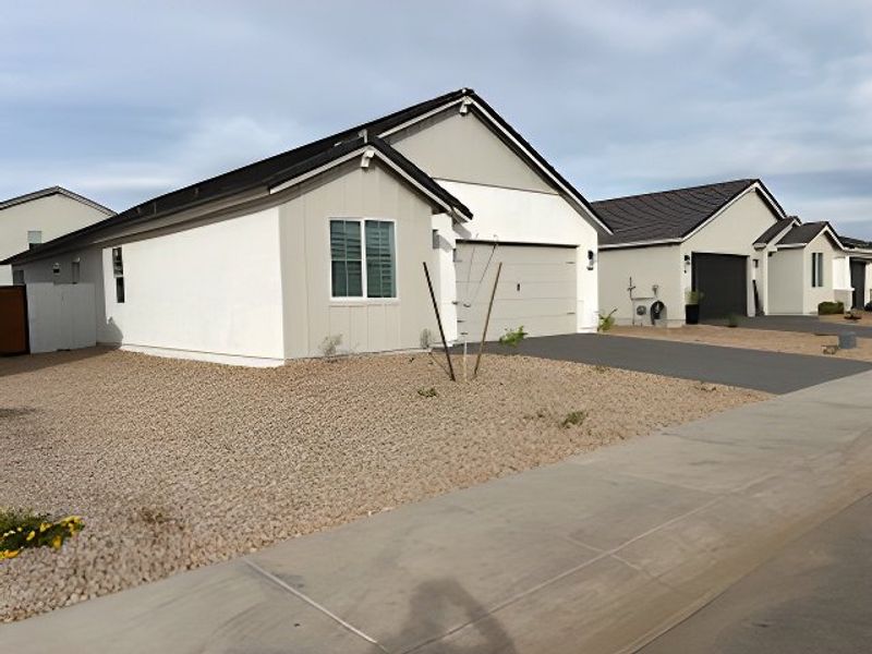 A modern white home with a gravel landscape in Pecan Cove by Newport Homes (San Tan Valley, AZ). A modern white home with a gravel landscape in Pecan Cove by Newport Homes (San Tan Valley, AZ).