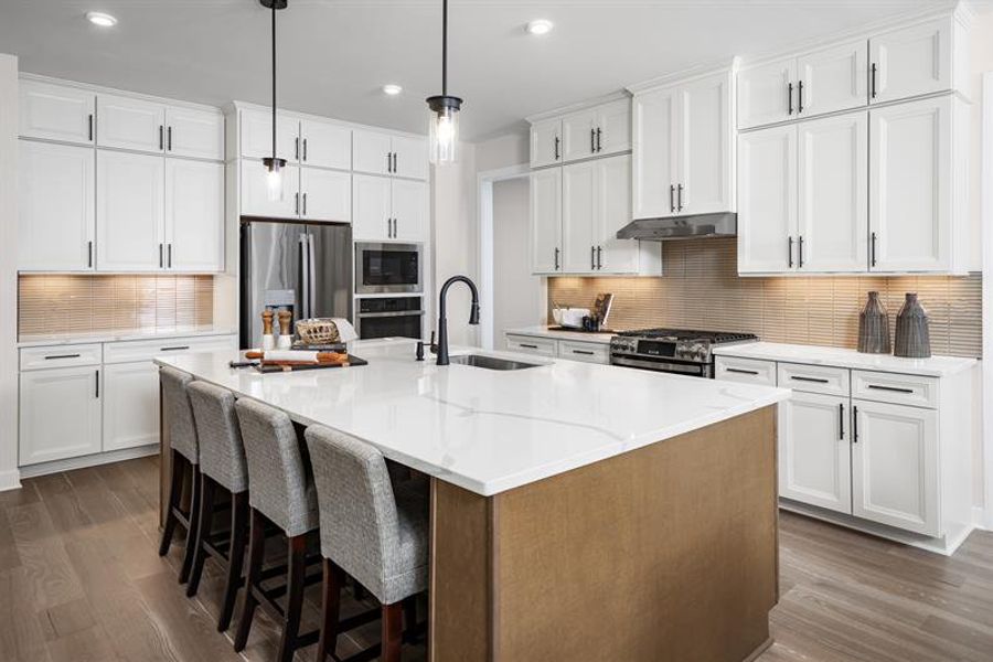 Side garage, hardwood floors, quartz counters, and more are all included at Huntcliff.