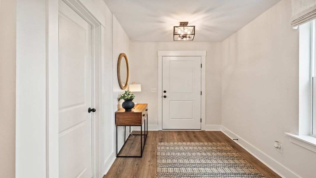 Welcoming foyer with stylish lighting and LVP flooring