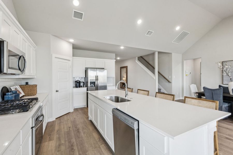 REPRESENTATIVE PHOTO – Kitchen in a Lakehaven Wimbledon model home in Farmersville TX by Trophy Signature Homes