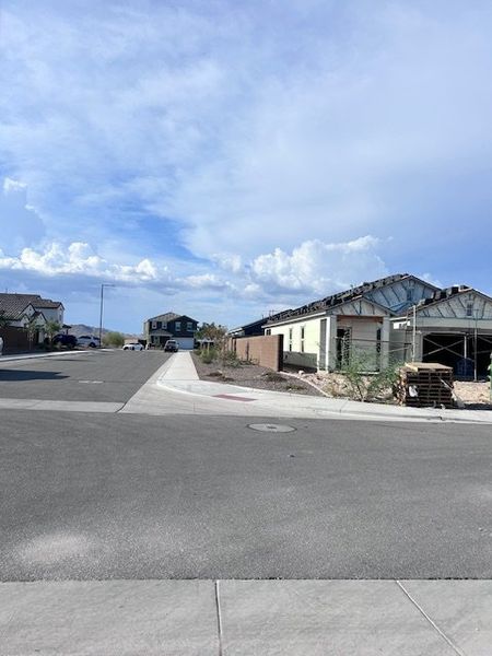 New homes under construction in Canyon Views by Starlight Homes, Litchfield Park, AZ. Expansive roads and clear skies.
